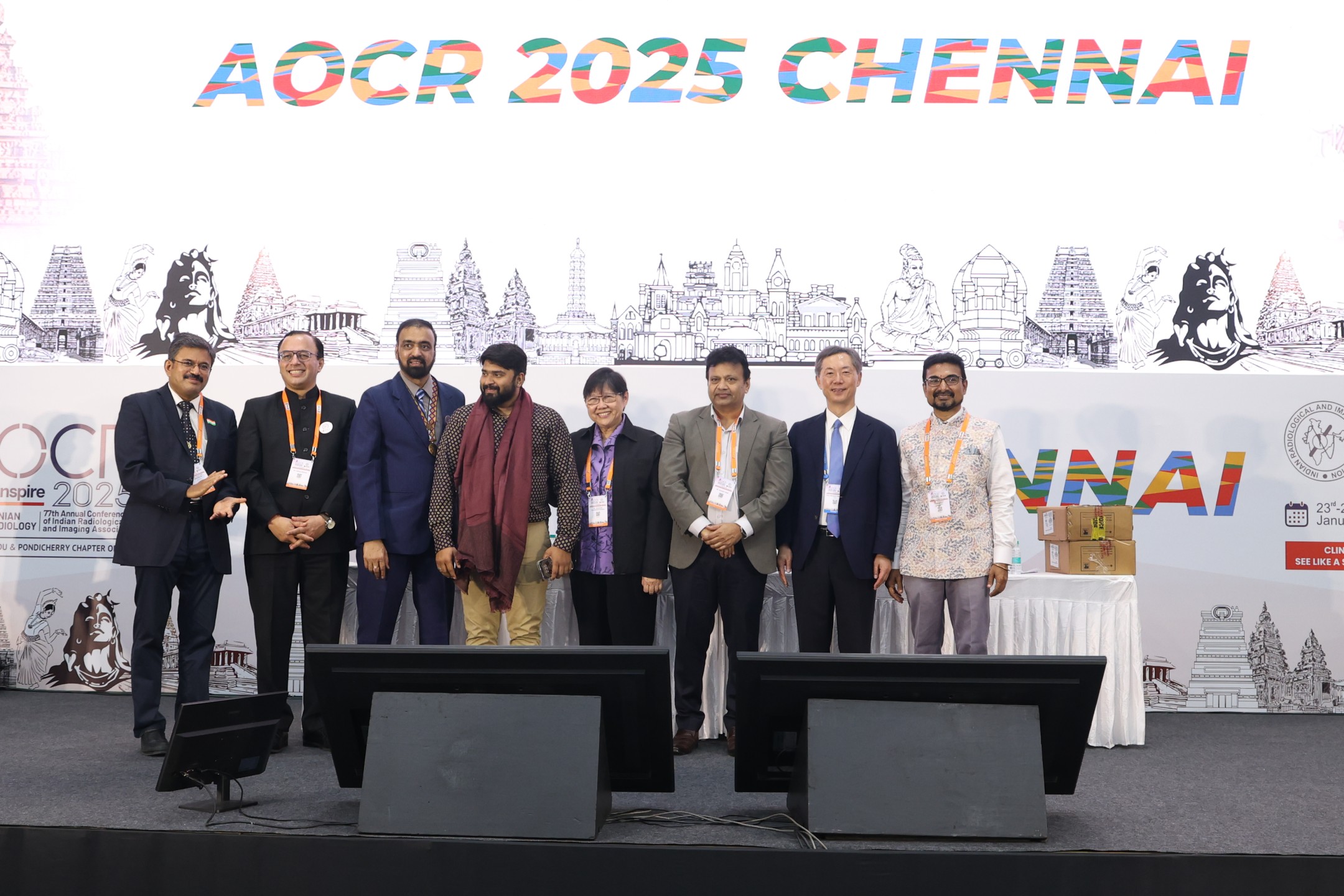 Folk artists in traditional costume welcoming delegates outside the AOCR 2025 venue